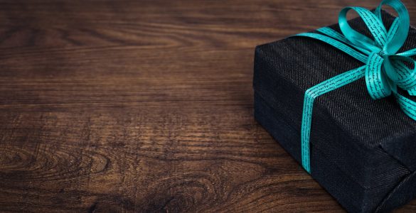 black gift box on wooden surface