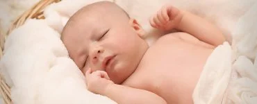 baby sleeping on white cotton
