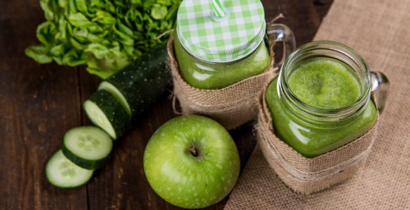 green apple beside of two clear glass jars