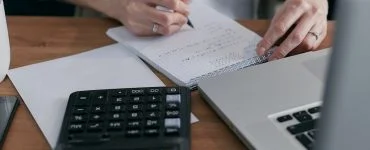 person calculating on a notebook