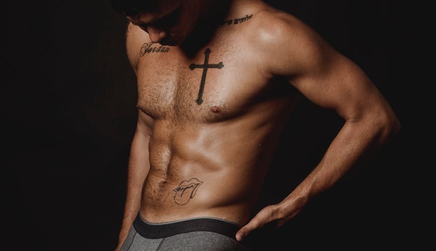 a tattooed man in his underwear